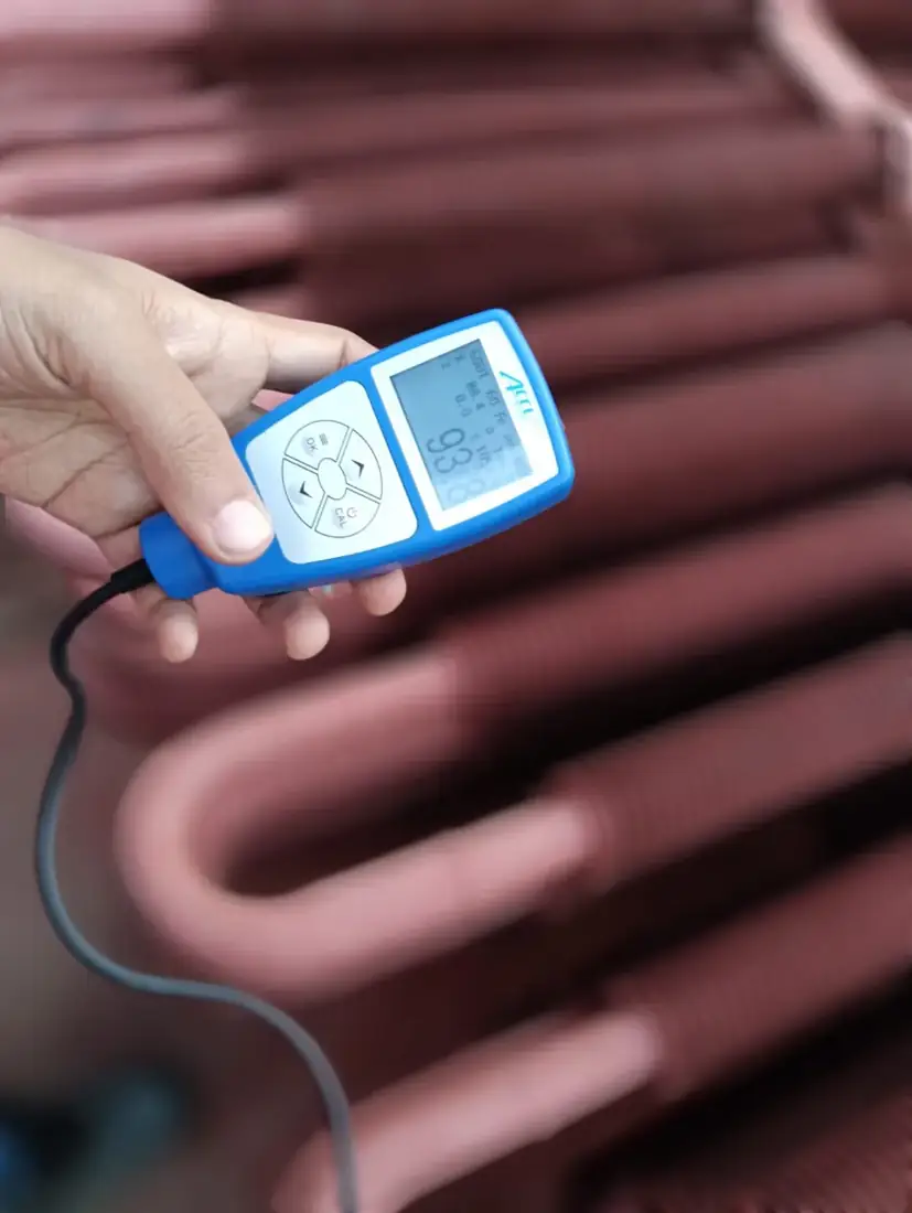 Ultrasonic thickness gauge being used on a formed bend